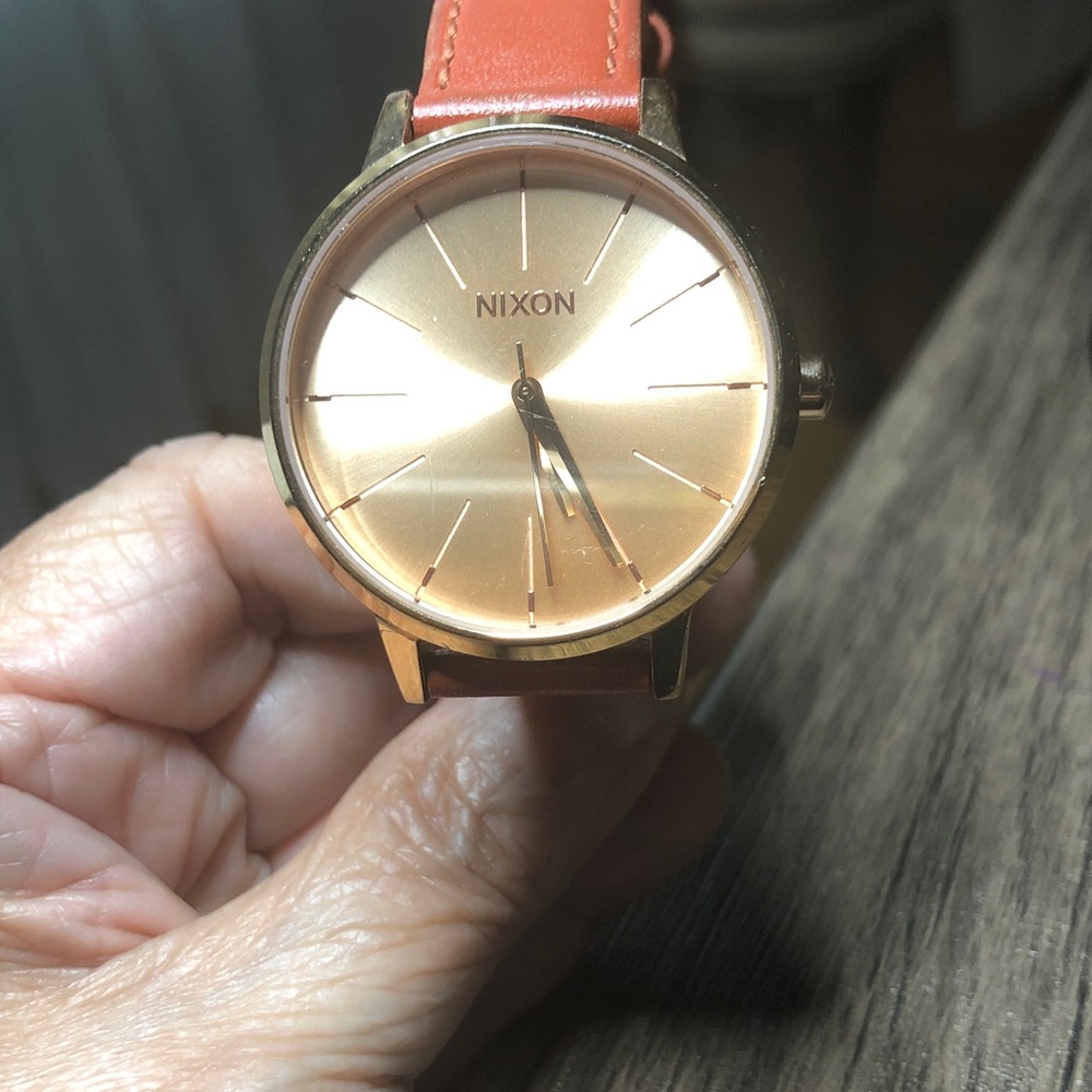 Nixon watch with box instructions and extra black strap. Woman’s watch.